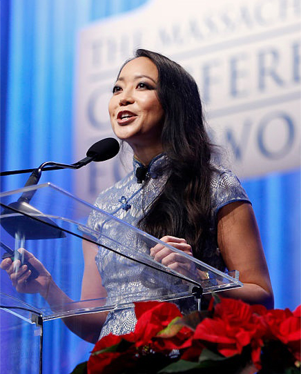 An image of Candy Chang speaking on stage at an event.