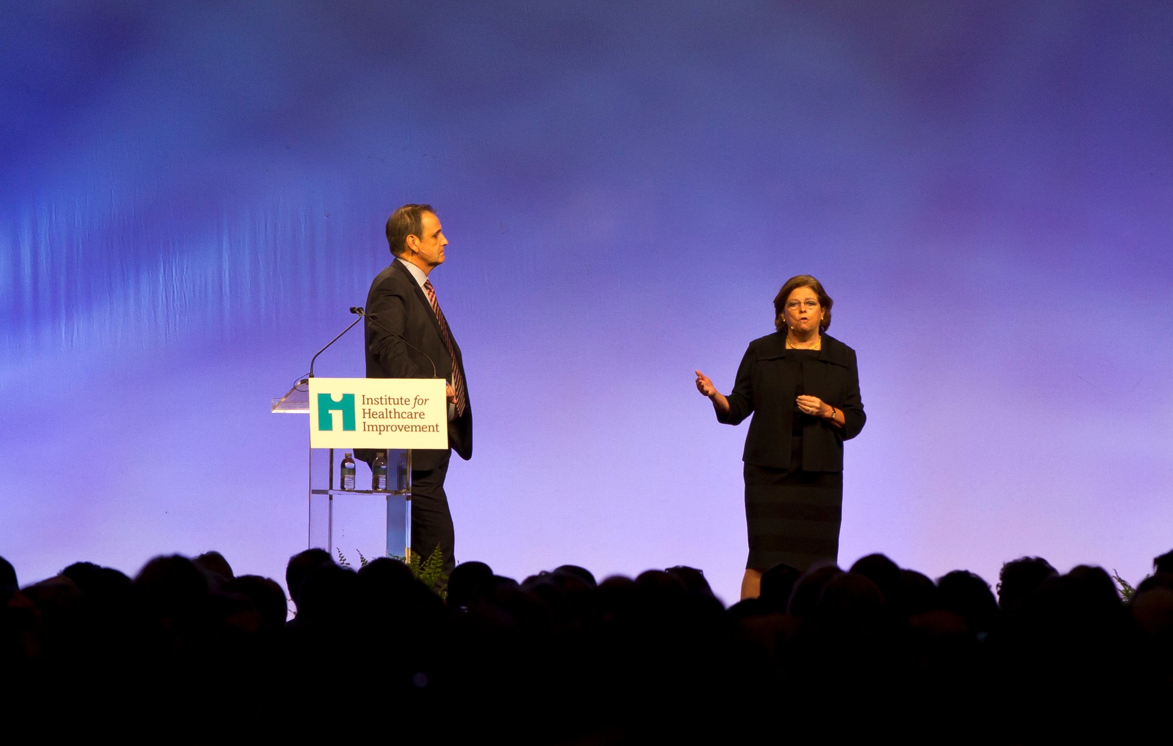 Derek Feeley (left) and Maureen Bisognano (right) giving a presentation on stage at an IHI conference.