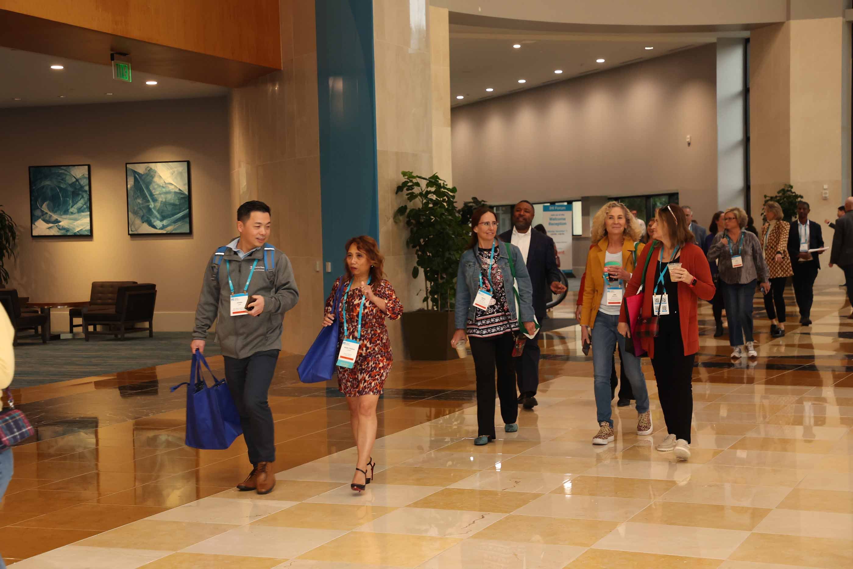 Conference attendees walking down the hall during the IHI Forum.