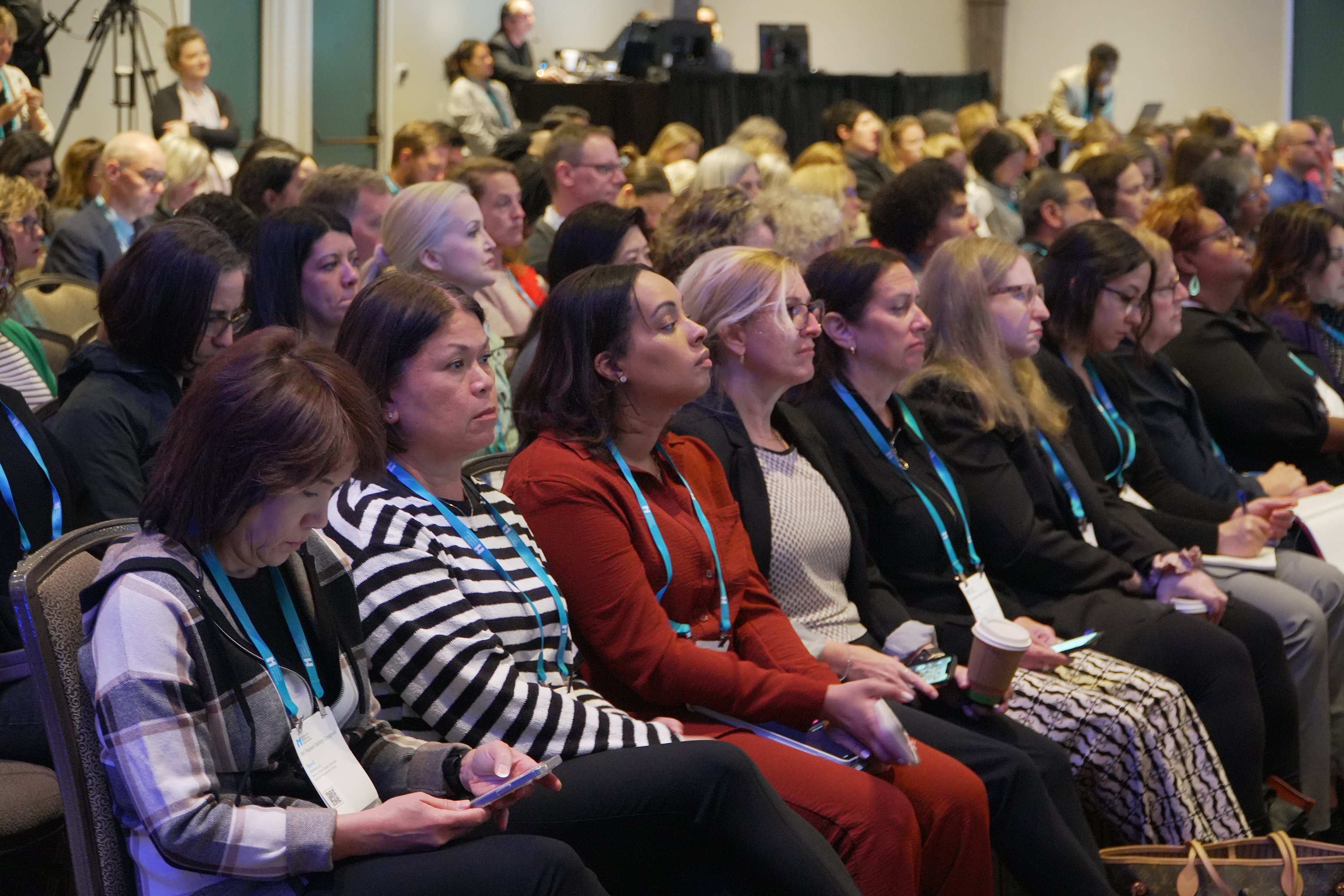 A group of people watching a presentation at an IHI conference.